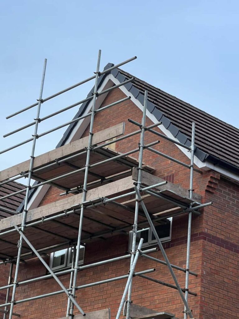 This is a photo of a roof which has just been repaired. There is a scaffold located at the gable end for access onto the roof. Works carried out by Tamworth Roofing Repairs