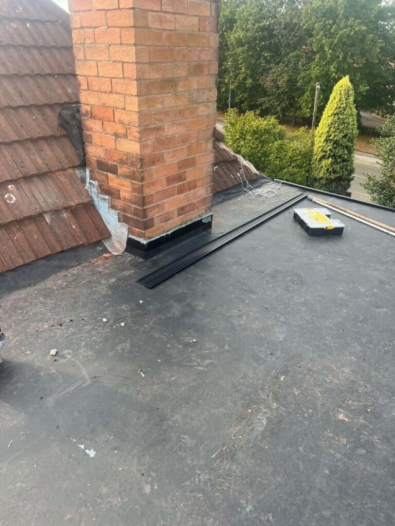 This is a photo of a flat roof which has just been repaired, there is also a chimney stack and some leadwork has also been dressed. Works carried out by Tamworth Roofing Repairs